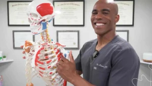 Patient receiving care from a chiropractor in Durham inside a mobile clinic.