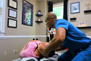 Chiropractor applying chiropractic techniques to relieve tension headaches in the cervical area.