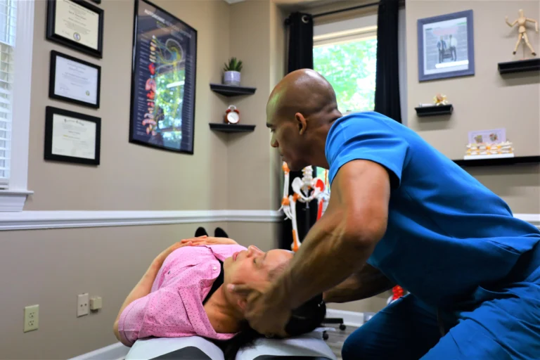 Chiropractor applying chiropractic techniques to relieve tension headaches in the cervical area.