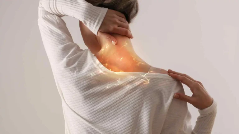 Person with hand on neck showing persistent discomfort, representing chronic neck pain.