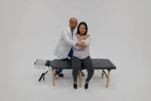 Chiropractor performing spinal adjustment on pregnant woman to relieve low back pain and improve posture.